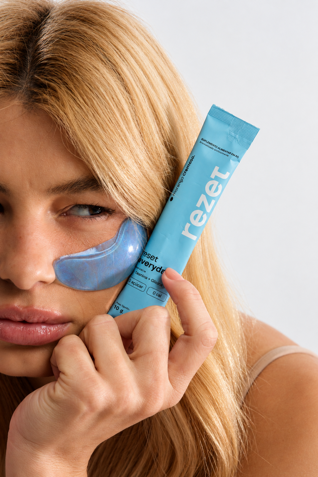 Mulher segurando um stick azul rezet junto ao rosto.
